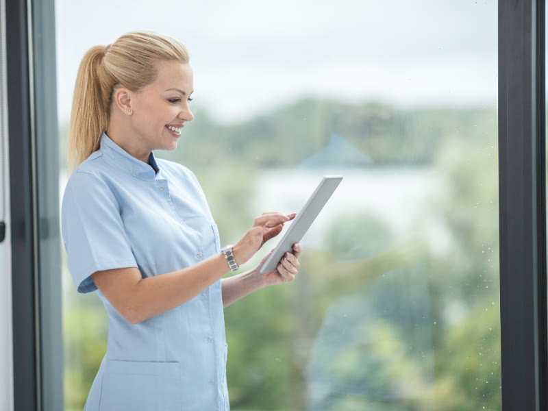 Profissional de enfermagem consultando um tablet